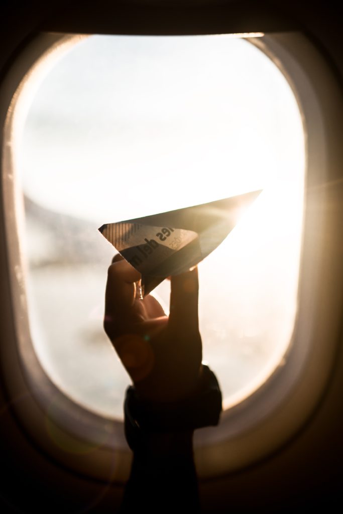 paper airplane in airplane window