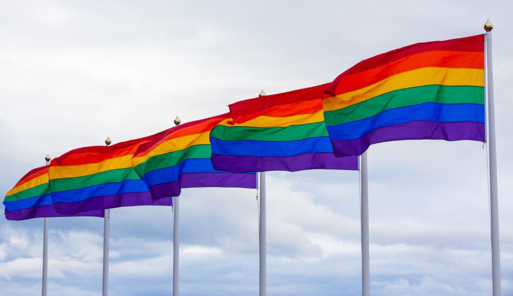 5 gay flags waiving in the wind