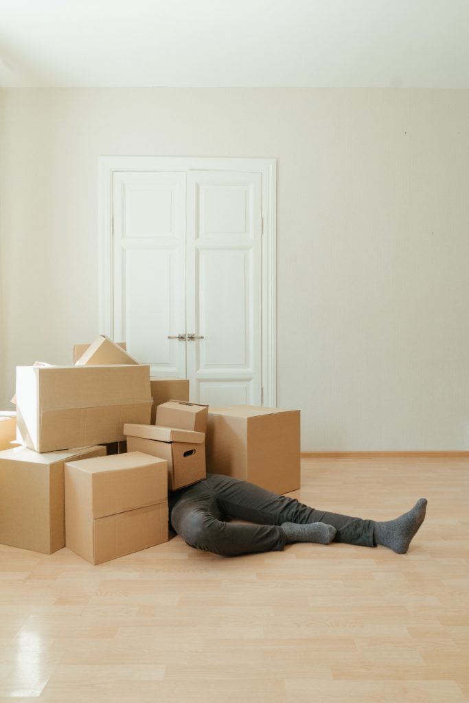 person under moving boxes