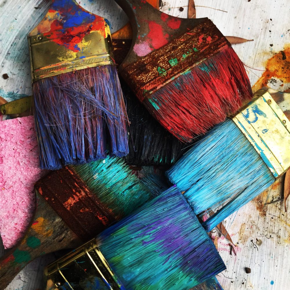 unwashed brightly colored paintbrushes signifying the war of art
