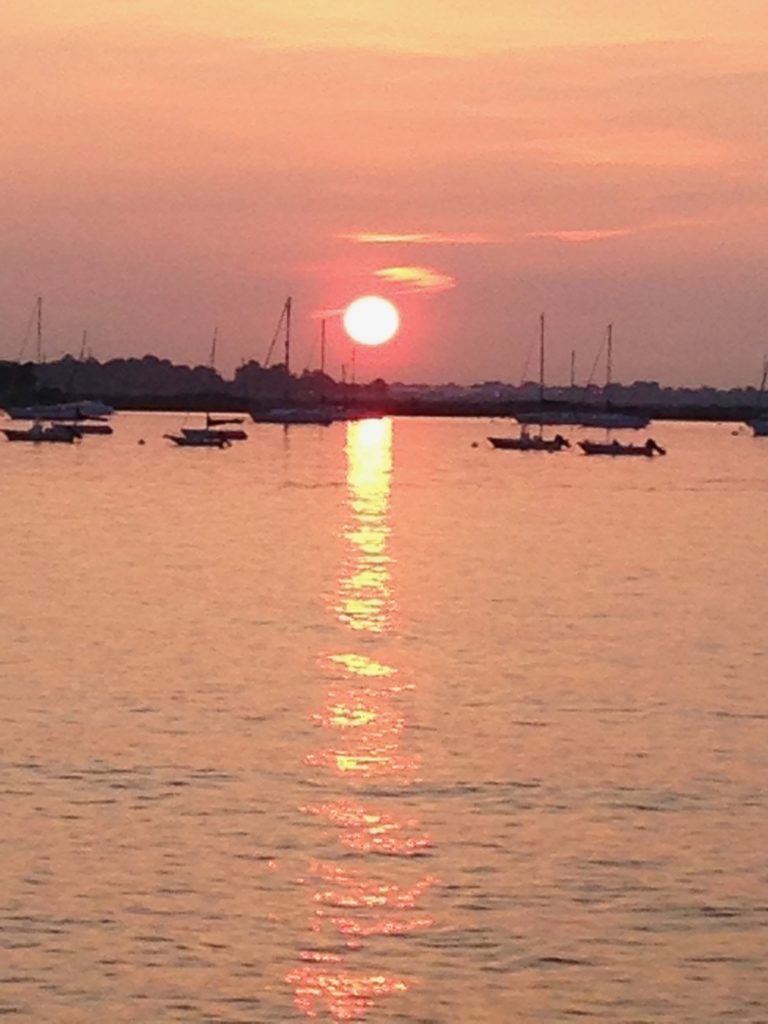 Orange sun ball over water