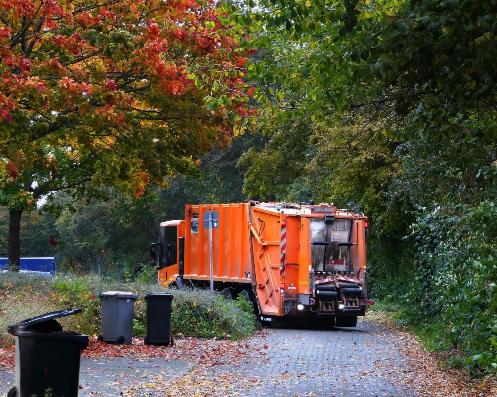 Garbage truck in autumn